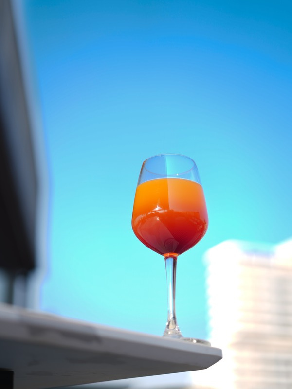 Aperol spritz against sky — beverage photography for hospitality brands