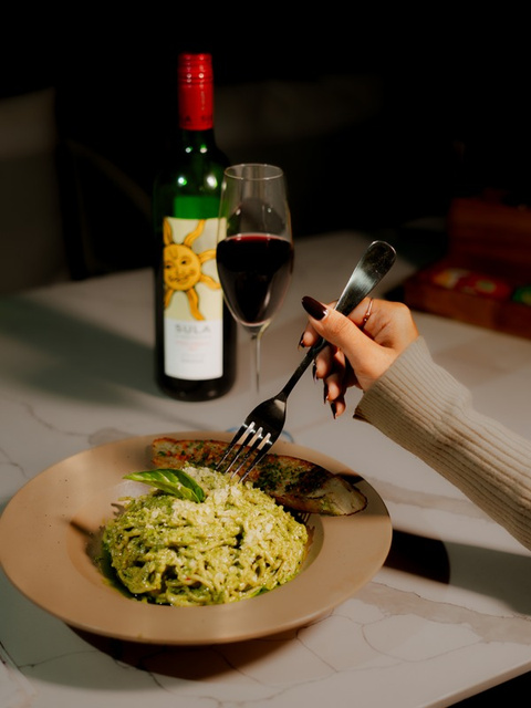 Pesto pasta with wine — restaurant menu photography